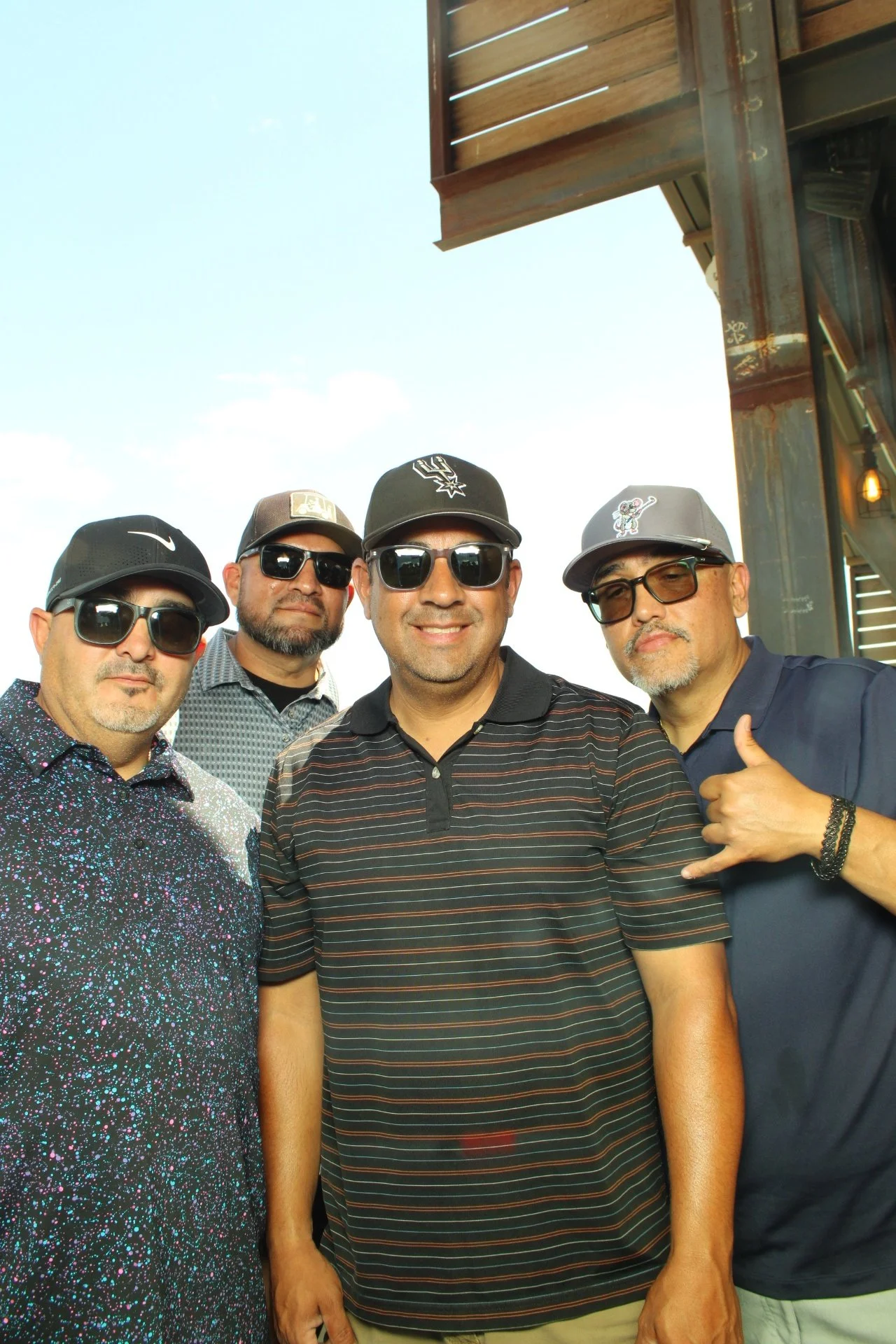 Golf Foursome posing for a sleek photo booth print at a Mission Ridge SpinShot Mirror Air Booth for a golf tournament event.