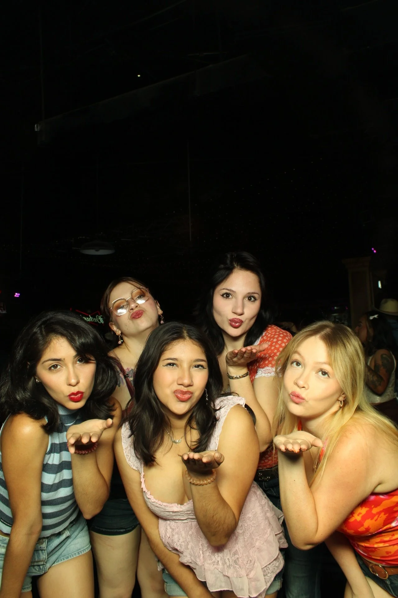 Group of friends interacting with the premium Mirror Air Booth at an El Paso party activation.