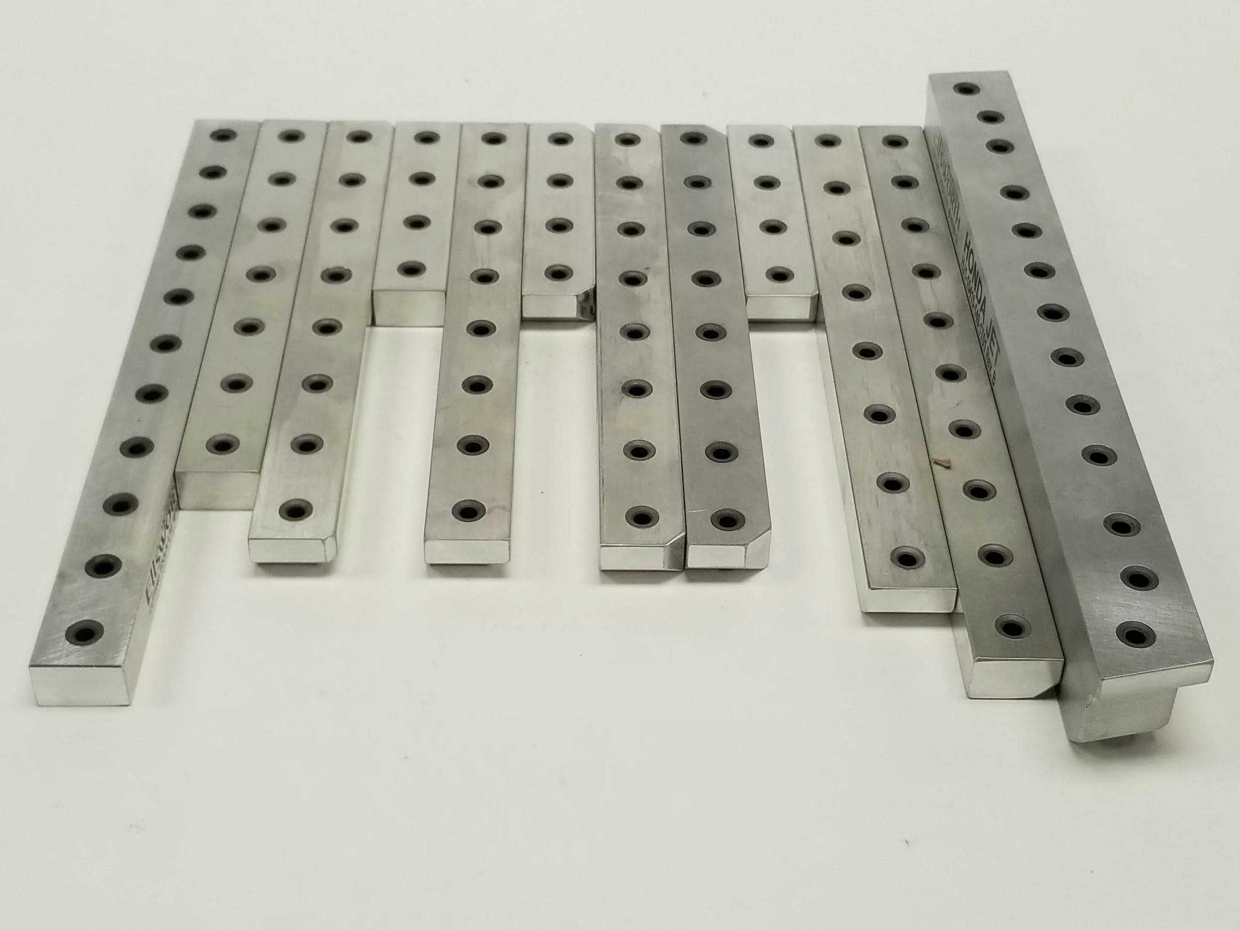 Custom drill jig rails with hardened bushings for precision hole location in high-volume manufacturing