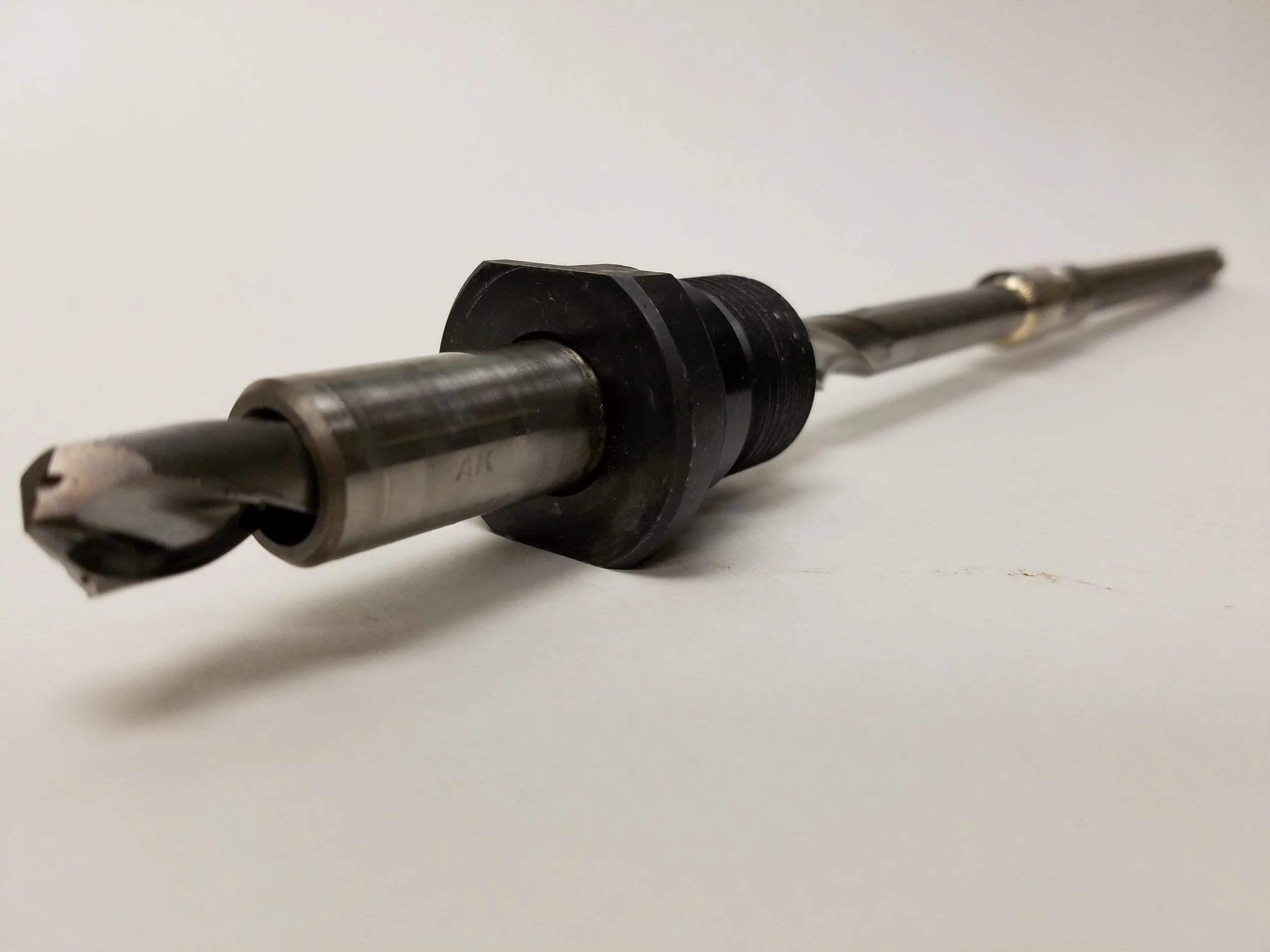 Custom coolant-fed step drill assembly for precision deep-hole CNC machining applications