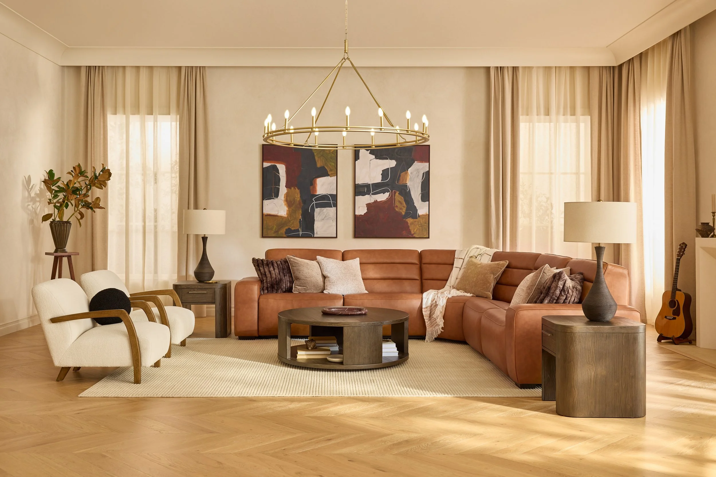 Living room with a leather sectional sofa, abstract paintings, a round coffee table, and various lamps. Windows with beige curtains and a guitar in the corner.
