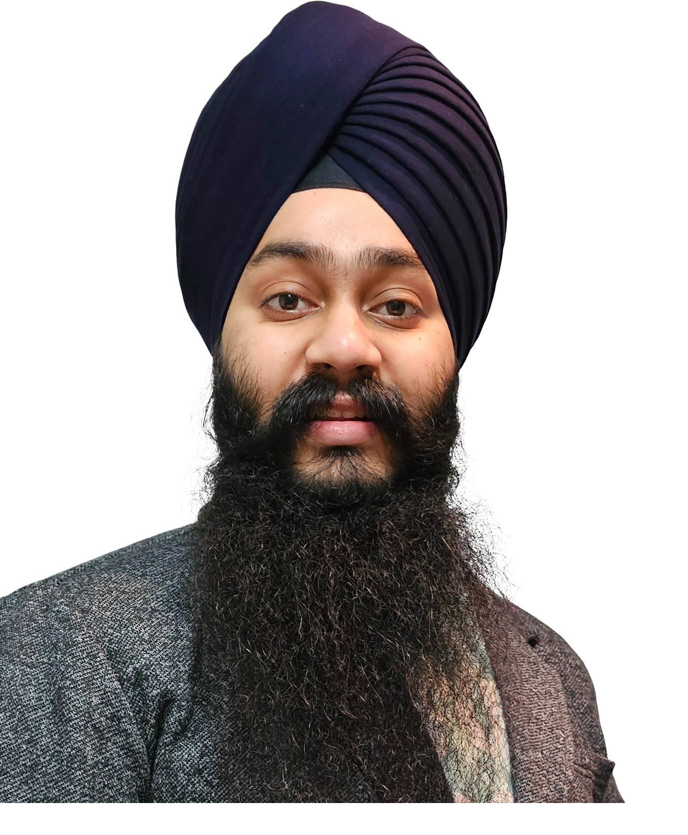 A man with a full beard wearing a dark blue turban and a gray blazer.