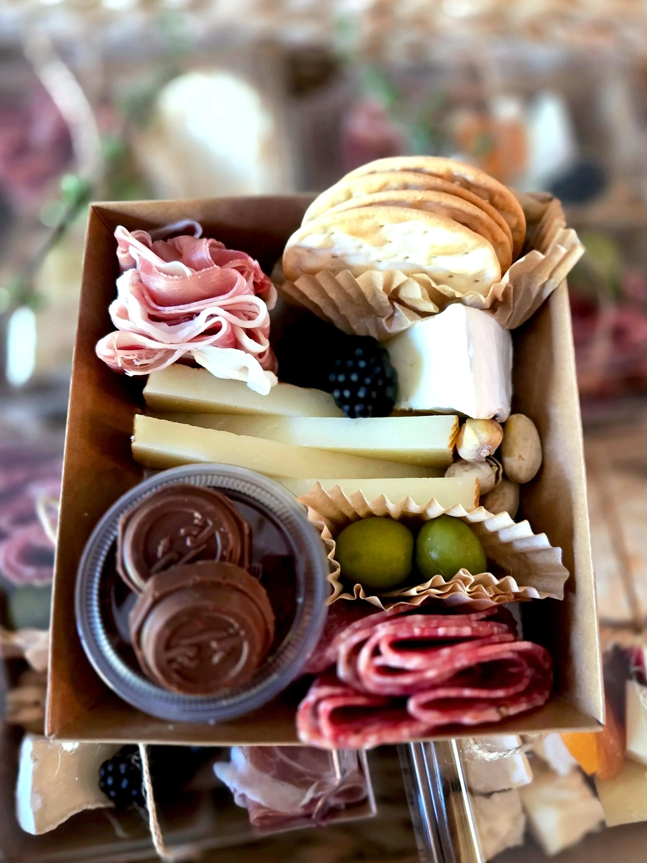 St. Uguzo's small tray  for one filled with assorted cheeses, cured meats, fruit, crackers, nuts, honey, and chocolate for solo snacking, business lunches, or gatherings. Serving Ventura County, Santa Barbara County, and Northern Los Angeles County.