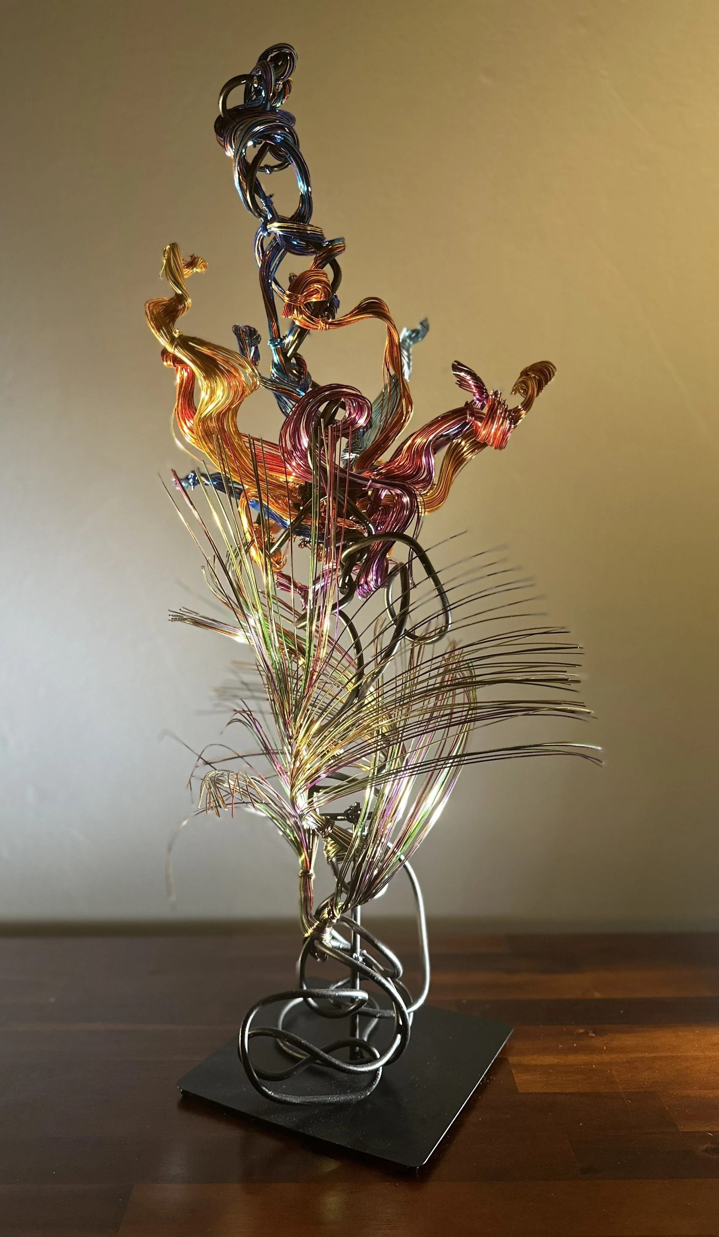 "Paradise" Detail view of base with spot lighting 
Description:  Color rising in a luminous, spiraling gesture — fluid forms lifting from a radiant base.

