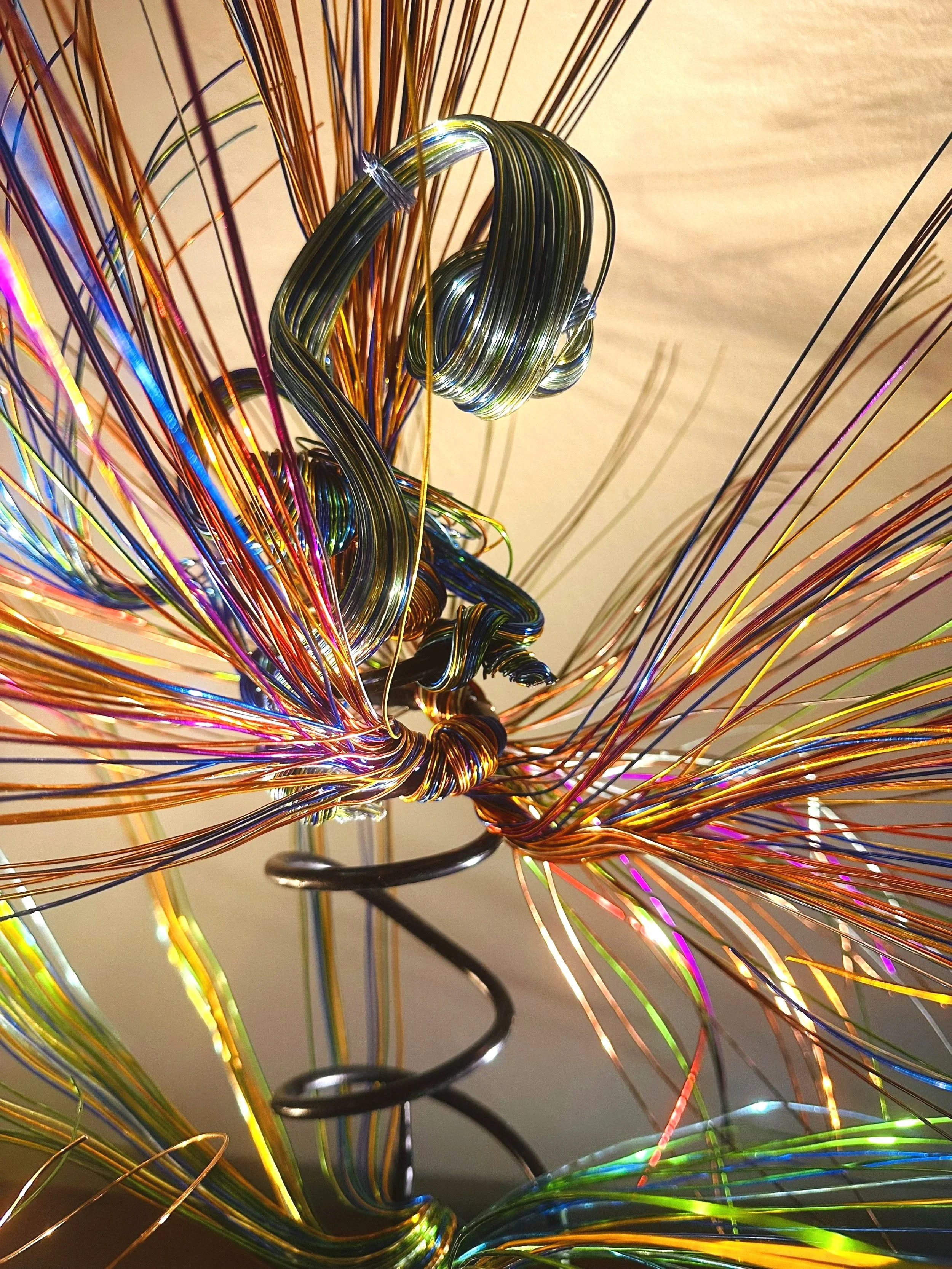 Title:  "Bloom"  Close up
Dimensions: 2' 0" × 2' 0" × 3' 0"
A slender vertical lift, the wires rising in a narrow column before drifting outward. It feels like a thin current of air carrying something upward.