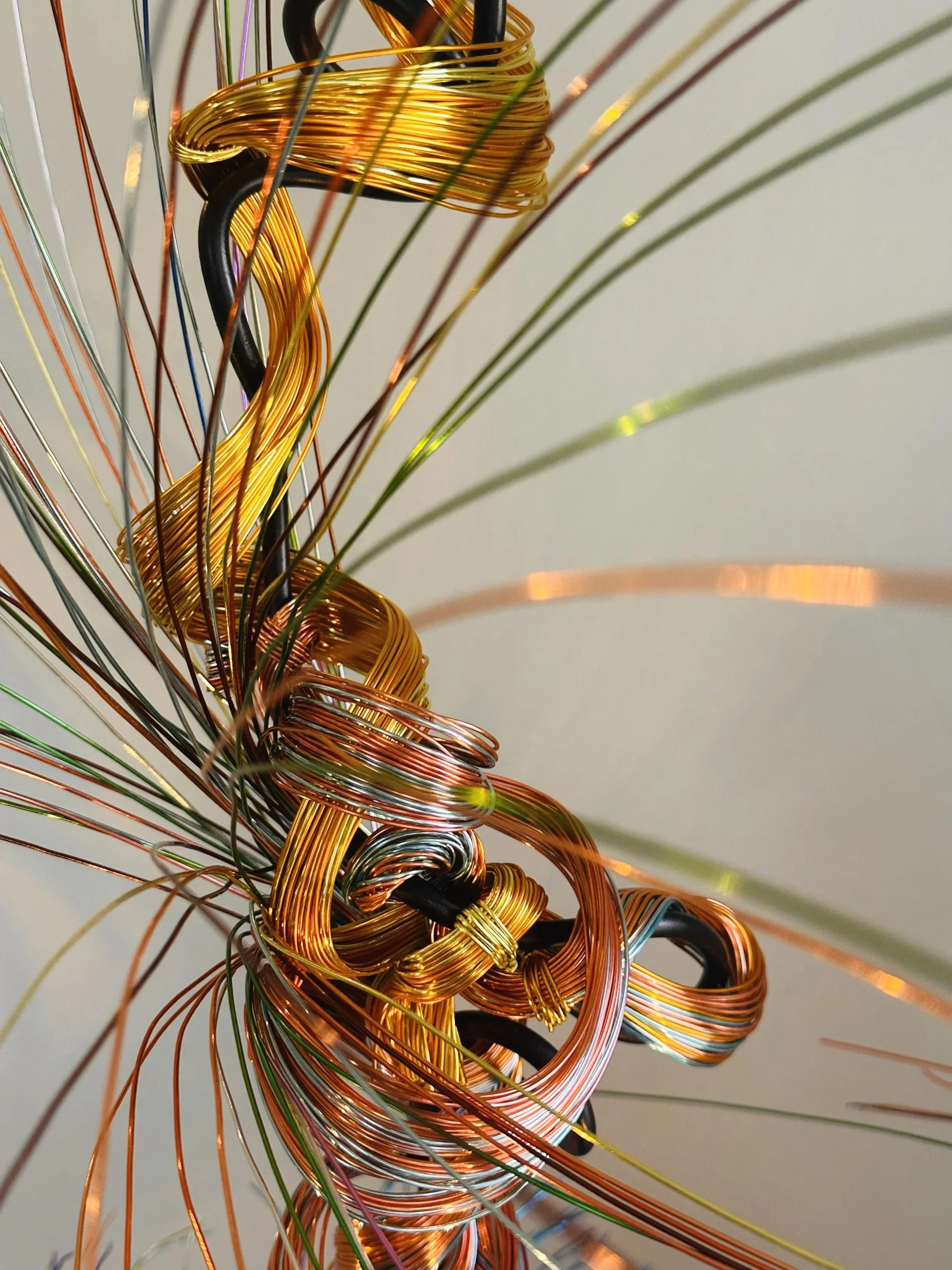 Title: Aglow in Motion.  Branch detail 
Dimension. 2" x 2" x 4".8' 
This detailed view of the piece explores the soft resilience of floral forms — branches lifting, colors gathering, and thin lines swaying as if touched by light. Shaped slowly by han