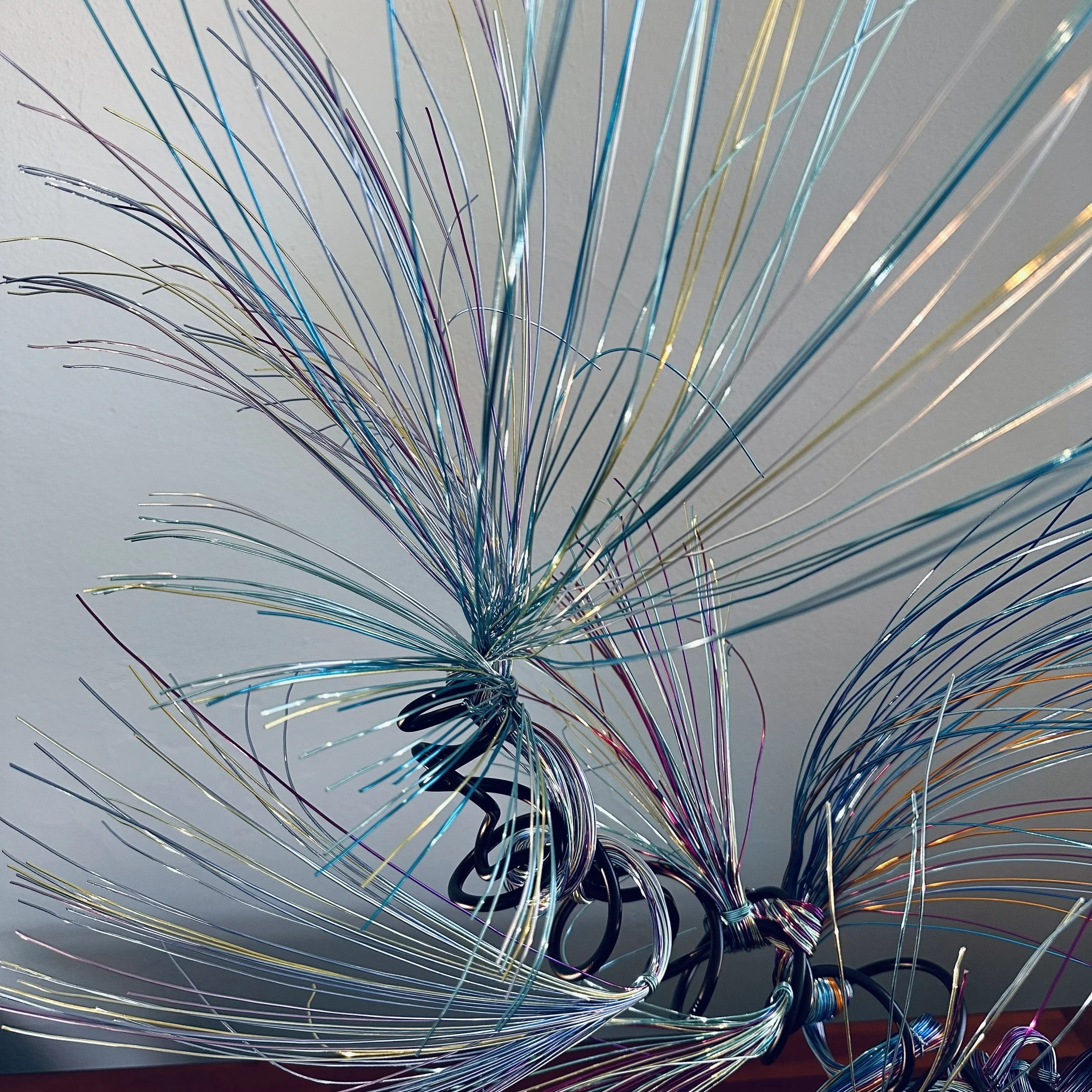 Title: "Rising"" View from front. Dimensions: 1' 6" × 1' 6" × 2' 5" The form stretches upward, its strands leaning into imagined air. A sculpture that feels mid movement — rooted below, reaching toward the sky