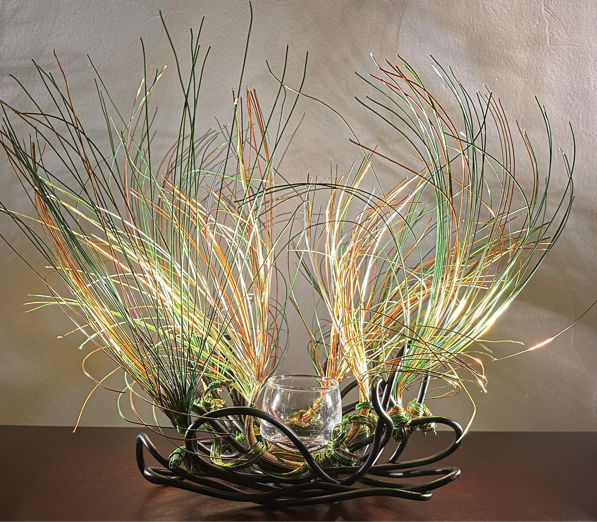 Title: "Swaying" Spot Lighting.   
Dimensions:  1' 6" × 1' 6" × 1' 6"
Wires rise in a gentle flare, as if catching the first hint of a breeze. A compact form with a quiet upward motion, holding the soft lift of something just beginning to open.


Han