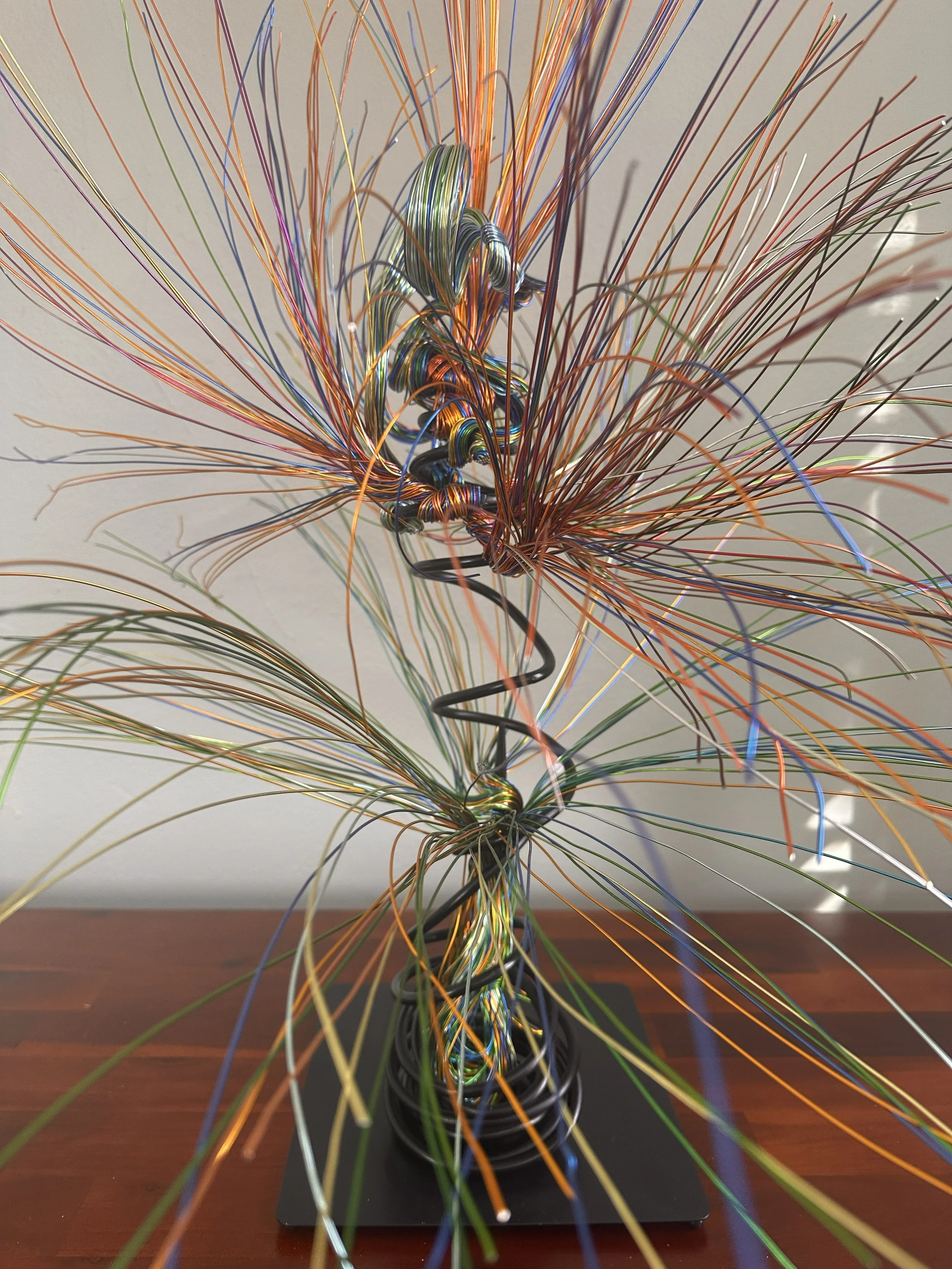 Title:  "Bloom" Close up. Detail #1
Dimensions: 2' 0" × 2' 0" × 3' 0"
A slender vertical lift, the wires rising in a narrow column before drifting outward. It feels like a thin current of air carrying something upward.