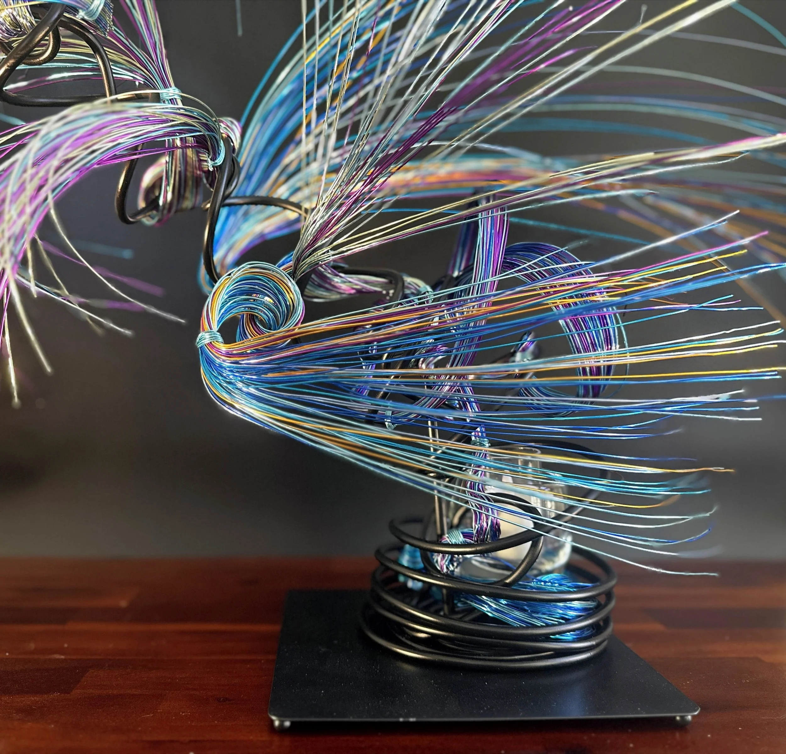 Title: "Rising"" View from front. Dimensions: 1' 6" × 1' 6" × 2' 5" The form stretches upward, its strands leaning into imagined air. A sculpture that feels mid movement — rooted below, reaching toward the sky