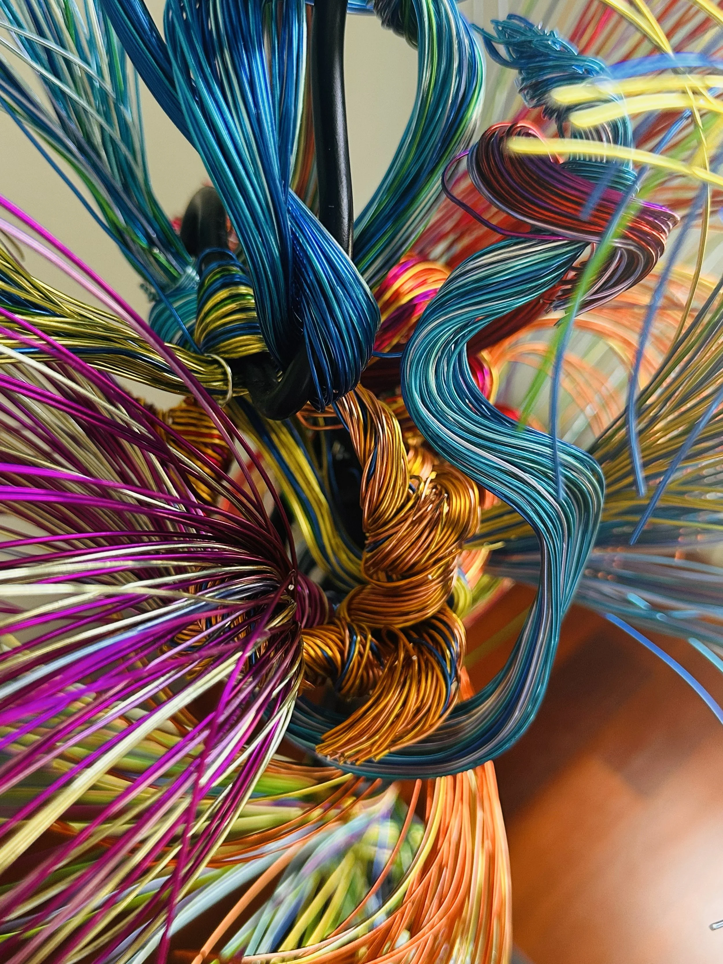 Title: Aglow in Motion. Core Detail #1  
Dimension. 2" x 2" x 4".8' 
This detailed view of the piece explores the soft resilience of floral forms — branches lifting, colors gathering, and thin lines swaying as if touched by light. Shaped slowly by ha