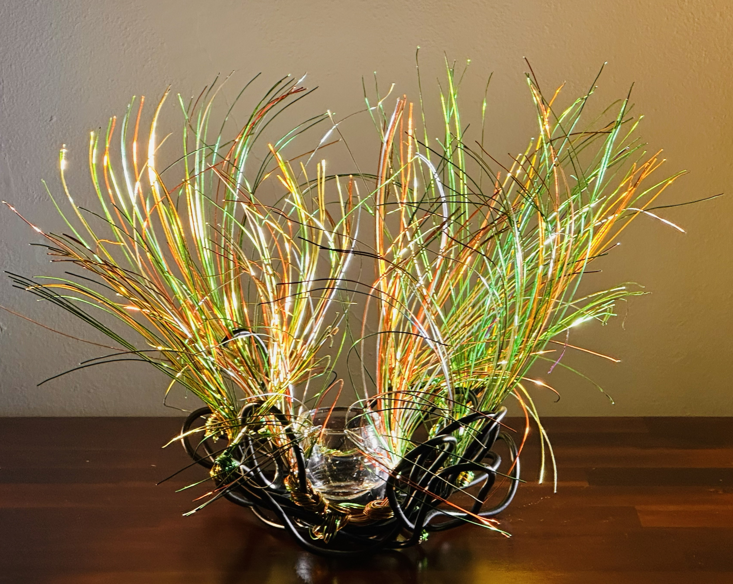 Title: "Swaying"  Spot Lighting. 
Dimensions:   1' 6" × 1' 6" × 1' 6"
 



Hand‑formed wire sculpture exploring botanical motion, light, and quiet atmospheric presence

