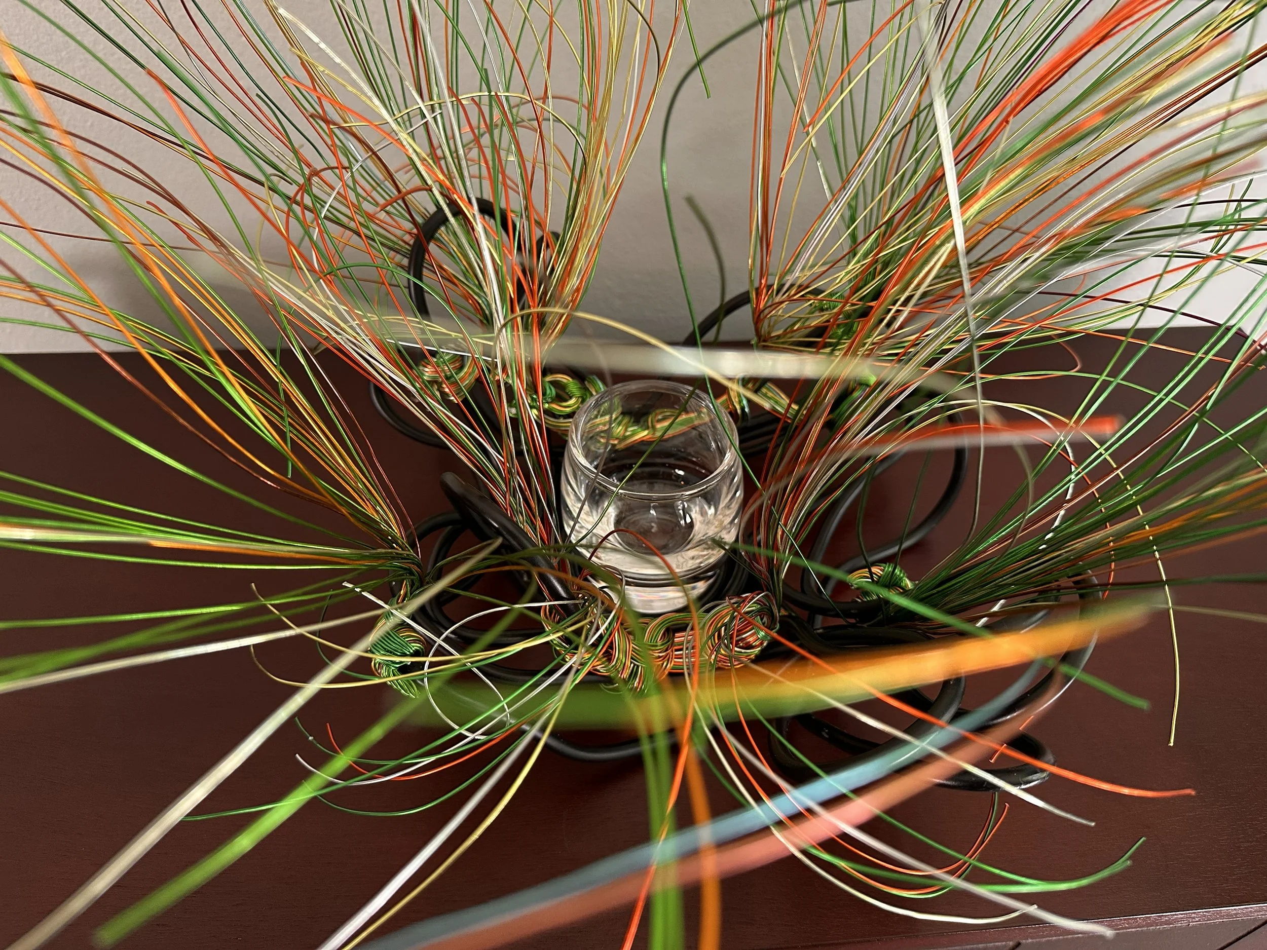 Title: "Swaying"  Aerial #2 
Dimensions:  1' 6" × 1' 6" × 1' 6"
Wires rise in a gentle flare, as if catching the first hint of a breeze. A compact form with a quiet upward motion, holding the soft lift of something just beginning to open.