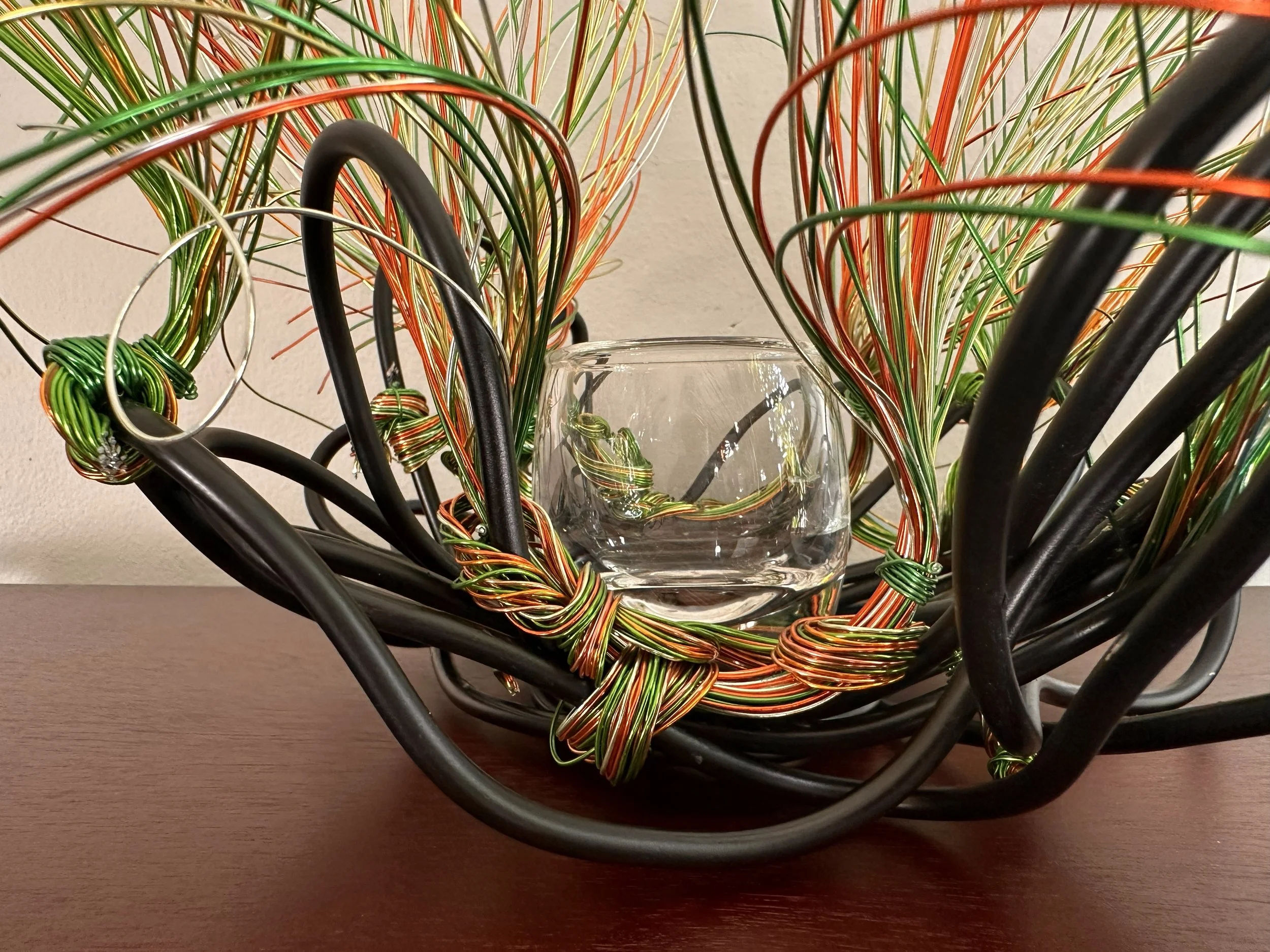 Title: "Swaying" View from front 
Dimensions:  1' 6" × 1' 6" × 1' 6"
Wires rise in a gentle flare, as if catching the first hint of a breeze. A compact form with a quiet upward motion, holding the soft lift of something just beginning to open.
