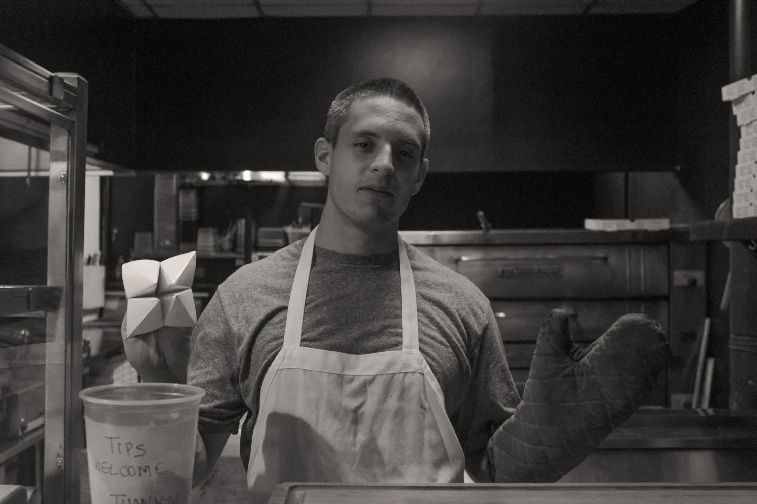 Man with fortune teller and oven mitt