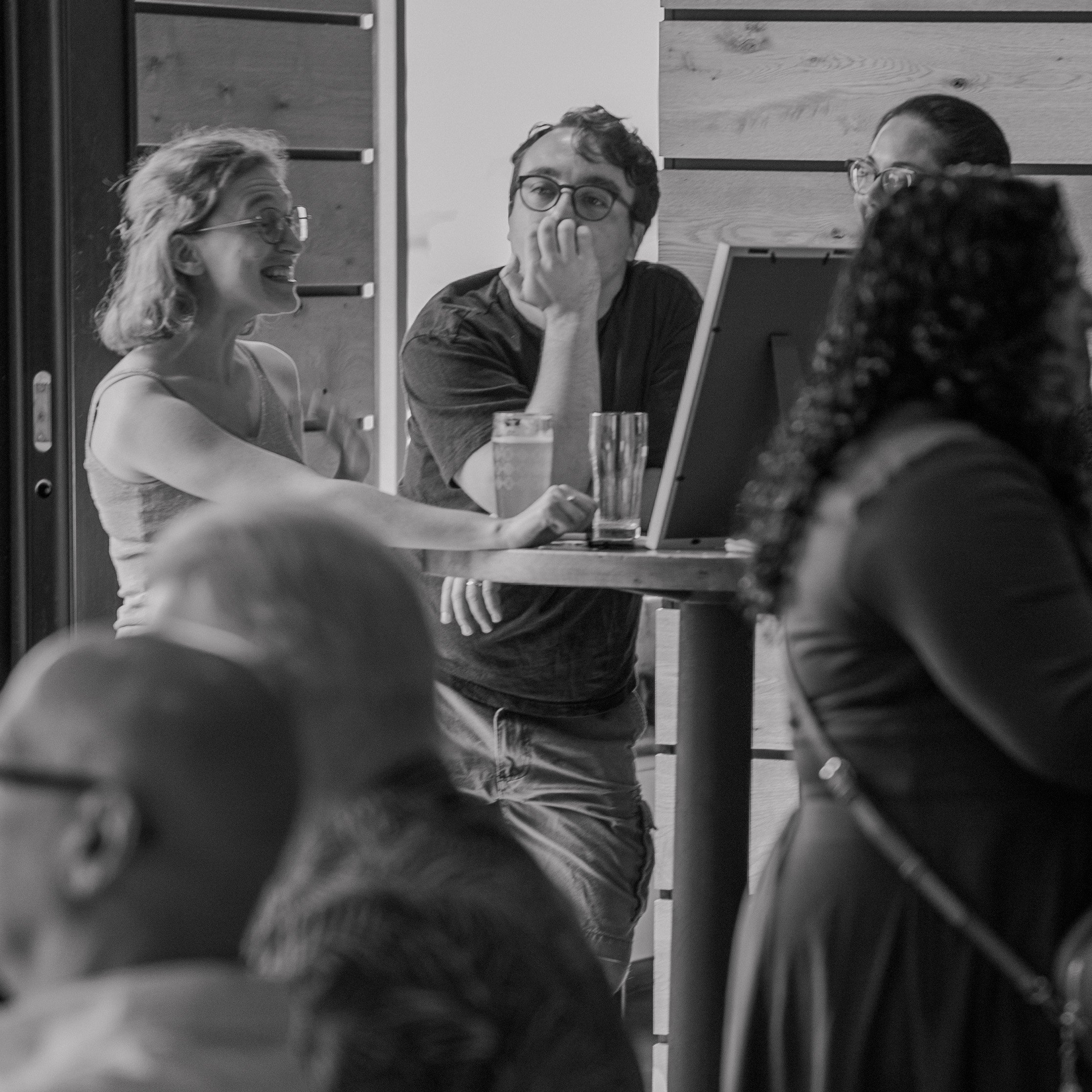 Man ponders while others conversate