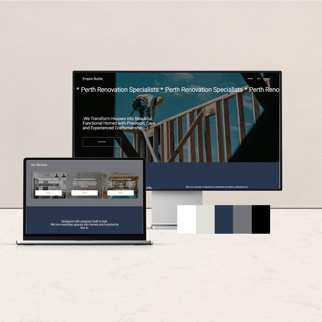 A computer monitor and a laptop display a website for a renovation company, with the monitor showing a construction worker on framing and the laptop showing service options, set against a plain wall with color swatches below.