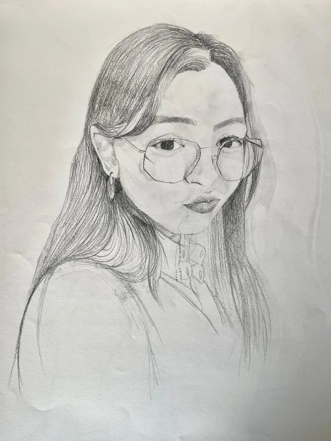 Pencil sketch of a young woman with long hair, wearing glasses, earrings, and a collared shirt.