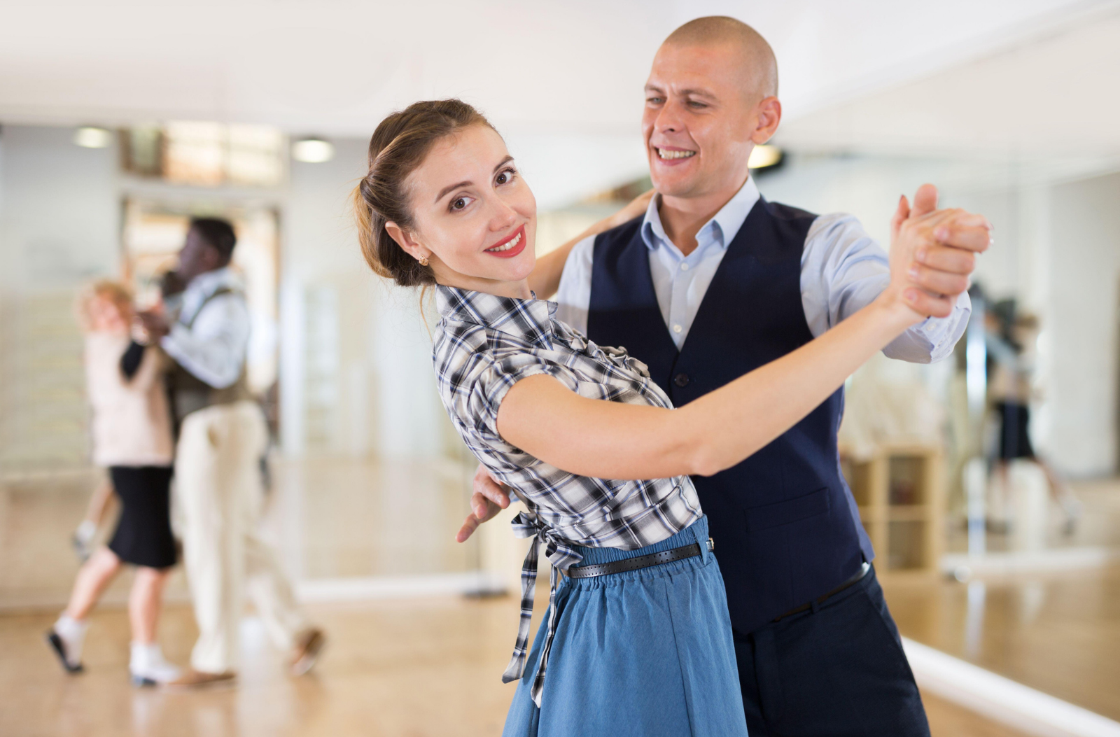 a happy couple learning how to dance