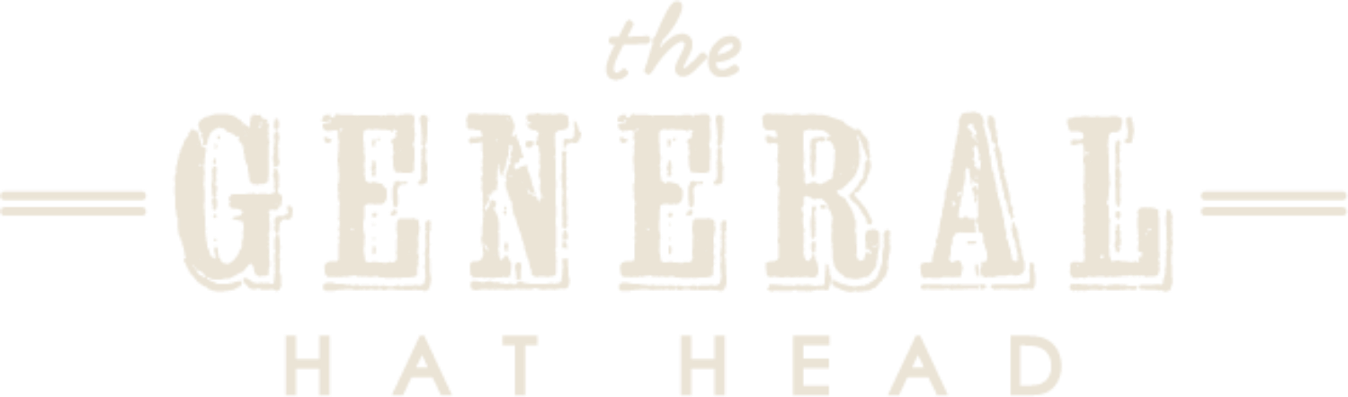 Vintage style logo with the words 'The General Hat Head' in distressed font, with horizontal lines on either side of 'the'.