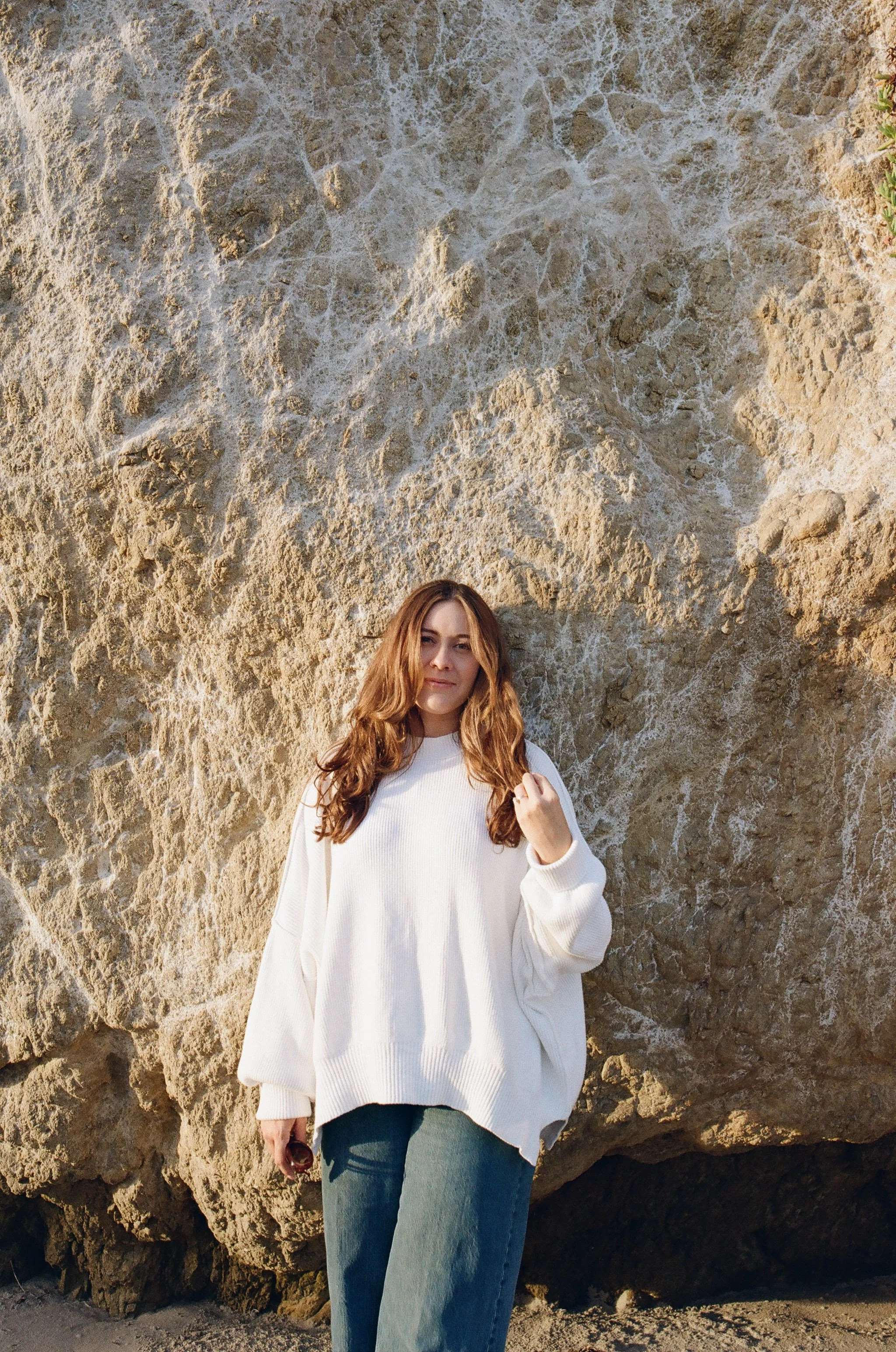 Portrait of Northern California wedding photographer on the Malibu coast, natural light editorial portrait with relaxed coastal styling.