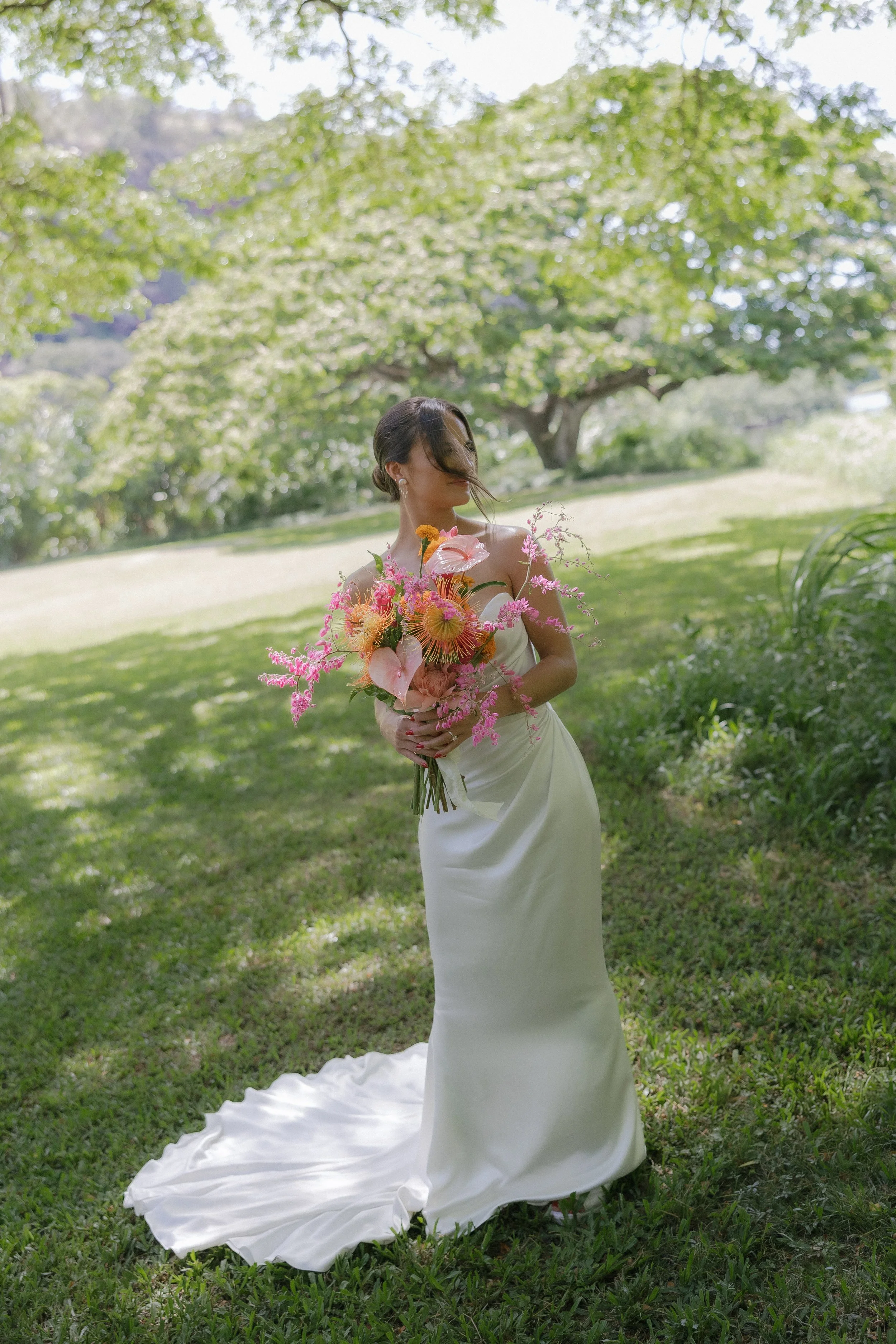 Bride wearing a Sarah Seven wedding gown with a modern, fashion forward silhouette, natural light bridal portrait outdoors.