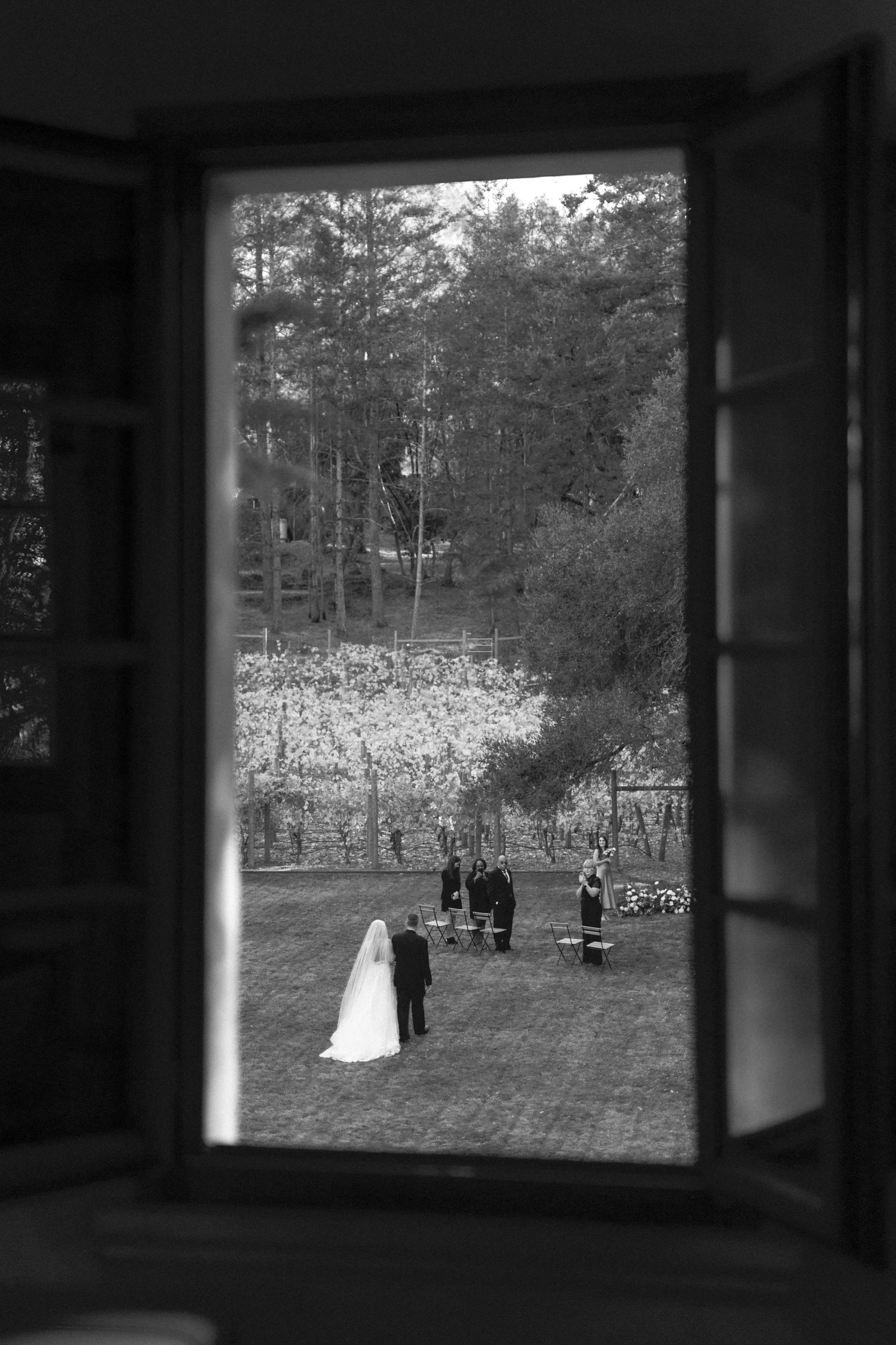 Black and white wedding ceremony at a private Sonoma château, intimate luxury celebration captured with a documentary perspective.