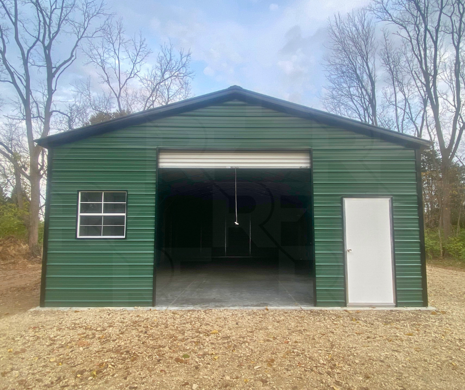 Completed green steel garage with vertical roof and horizontal siding