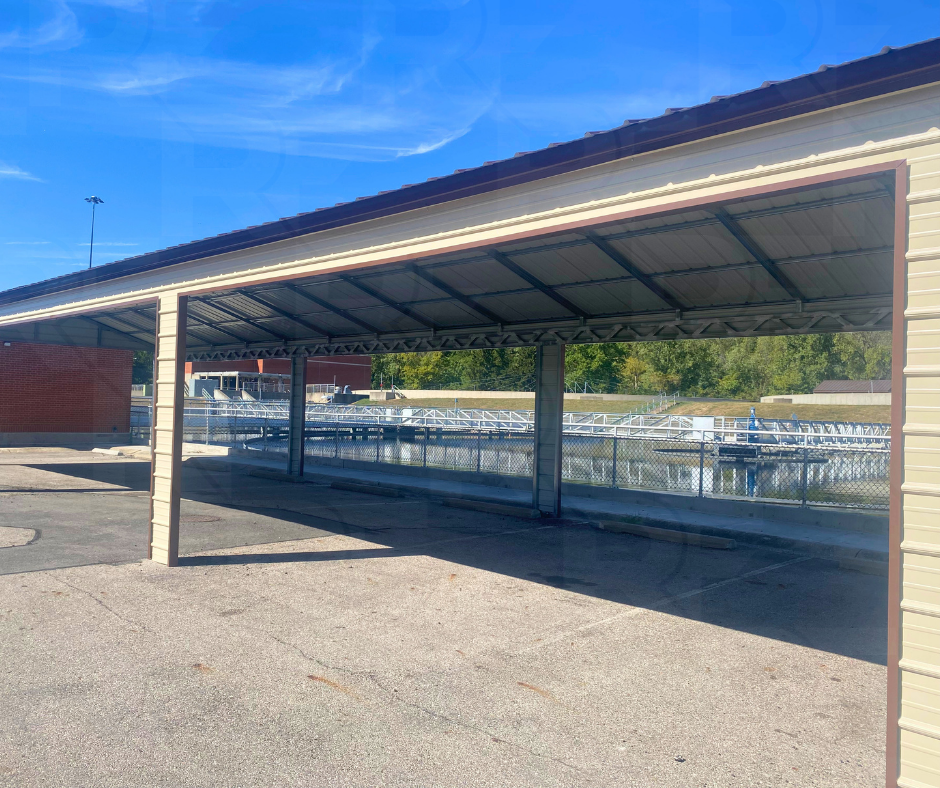 Custom six-bay metal carport for residential vehicle storage.
