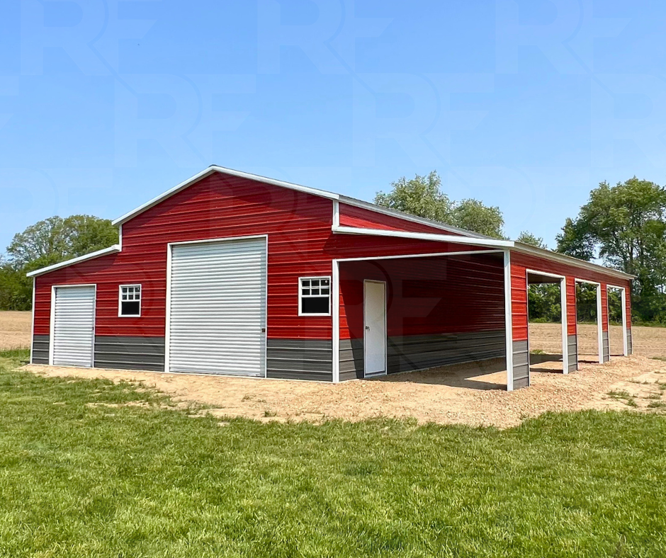Red and gray metal barn with multiple large doors, small windows, and lean-tos. Ag style building.