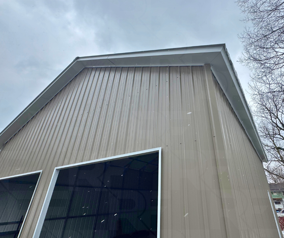 Close-up of the 6/12 roof pitch and overhang details on a steel garage.