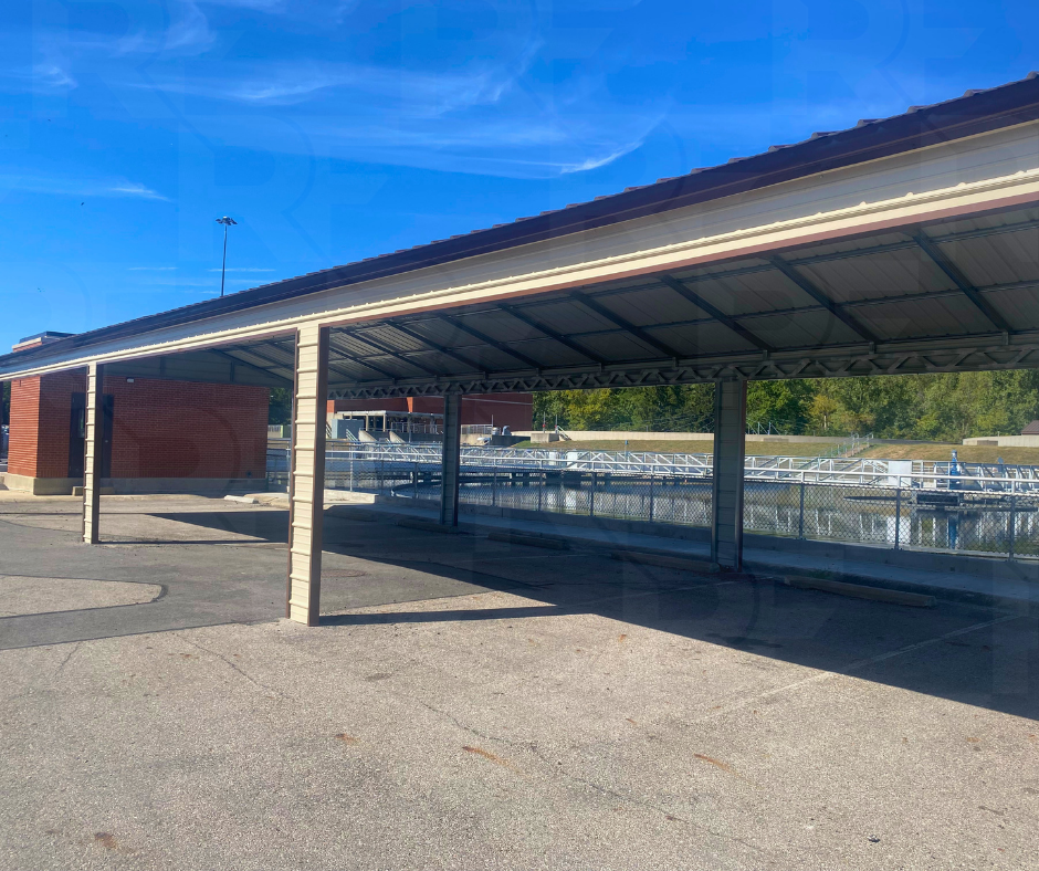 Large multi-vehicle steel carport with six covered parking bays.