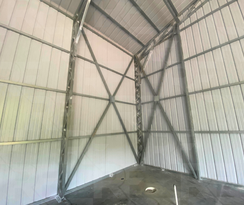 Metal equipment garage with 18-foot leg height and center divider wall.