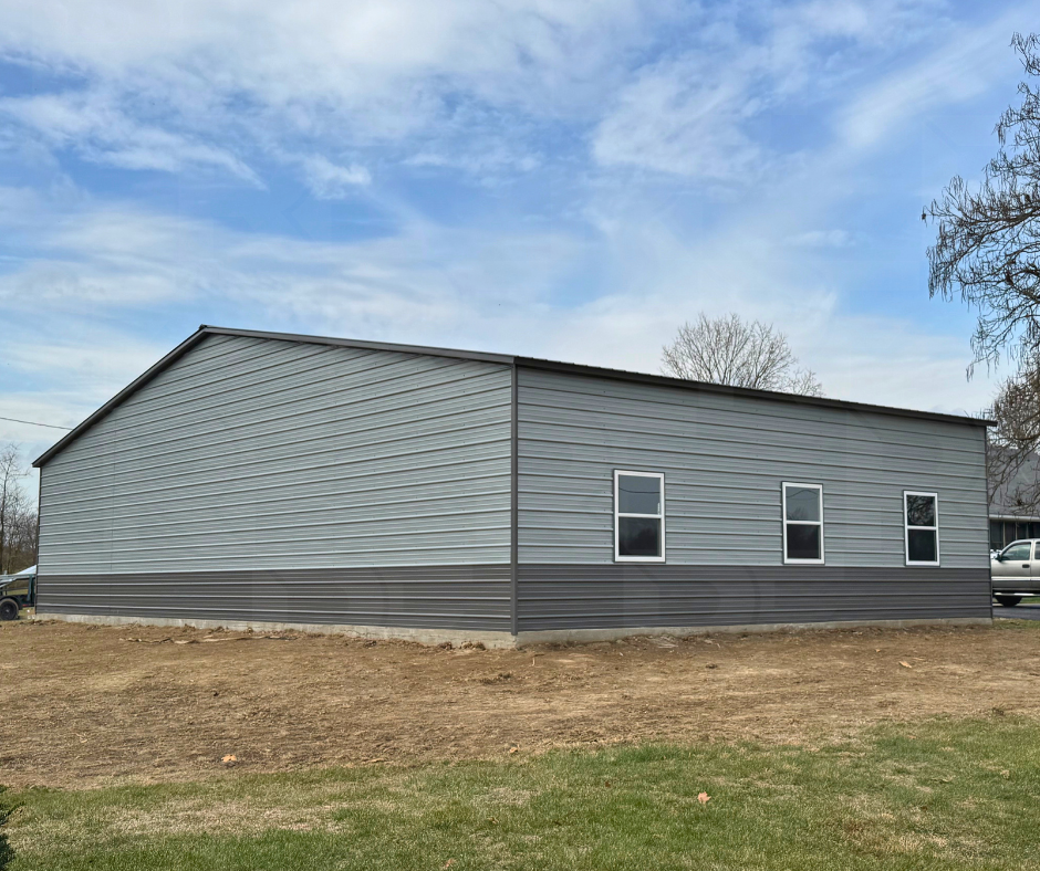 Side view of custom 54×35 steel building with enclosed lean-to additions near Troy, Ohio.