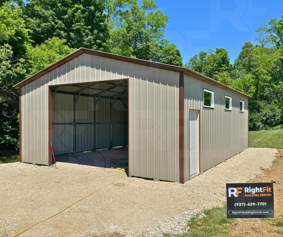 Metal storage building with large garage door and windows