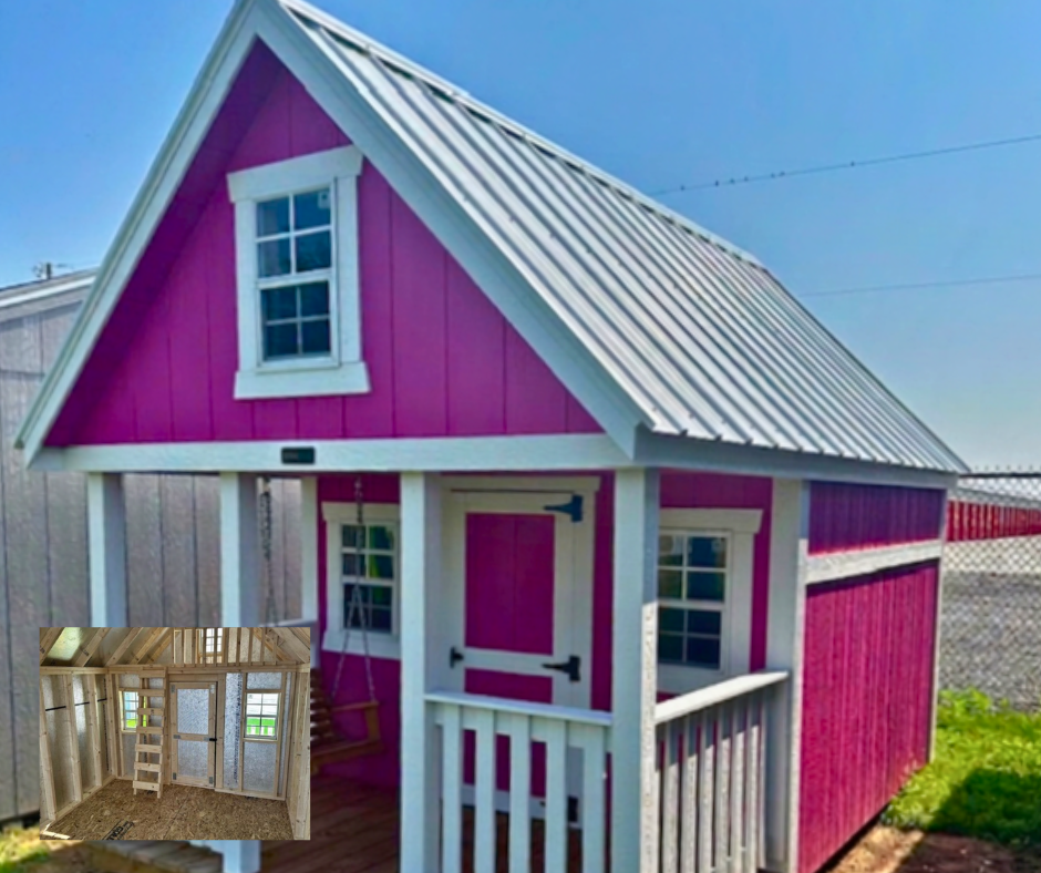 A colorful playhouse painted bright pink with white trim, metal roof, front porch, and small windows. The house is outdoors next to a chain-link fence, with a blue sky background.