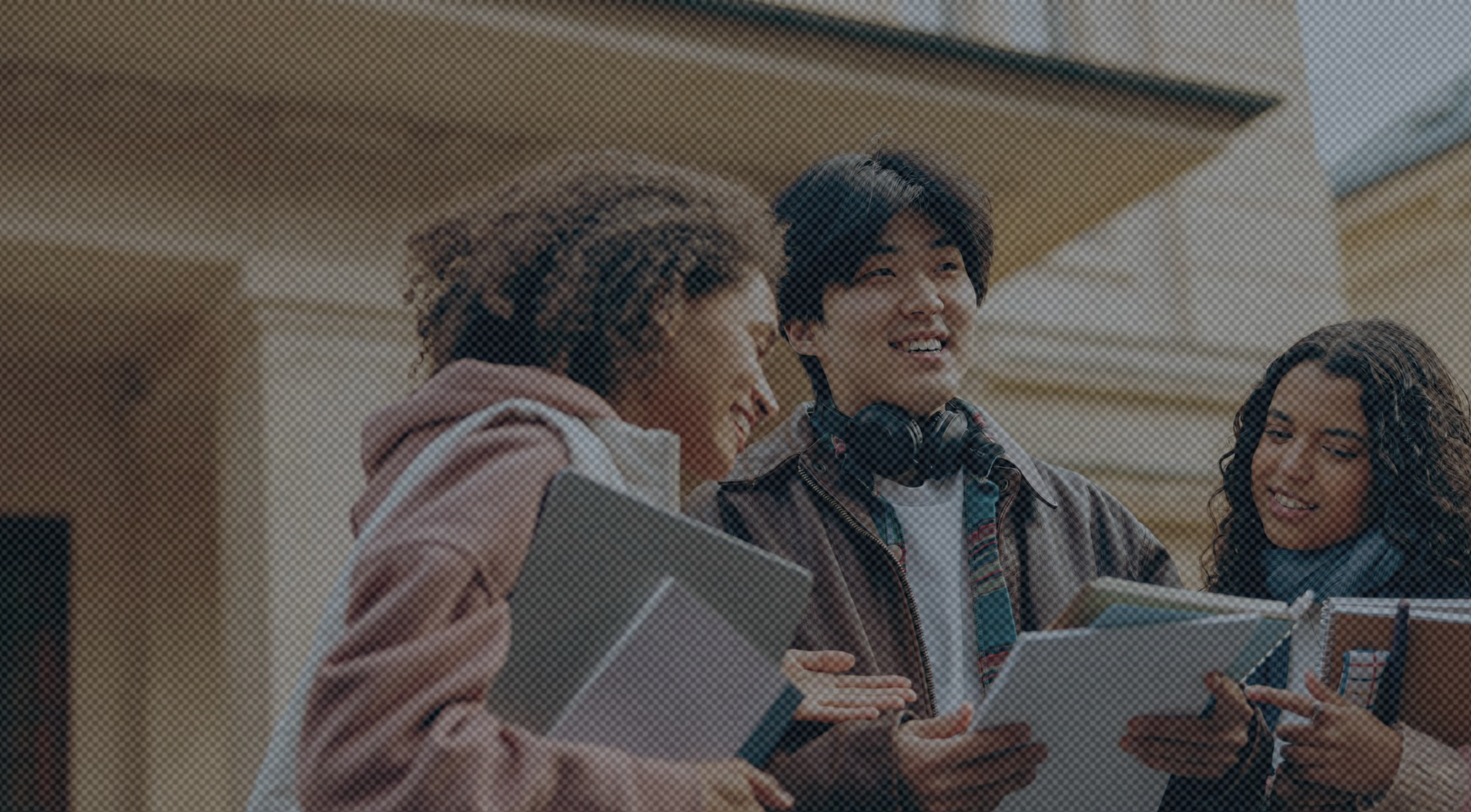 A group of students smiling while looking at their notes