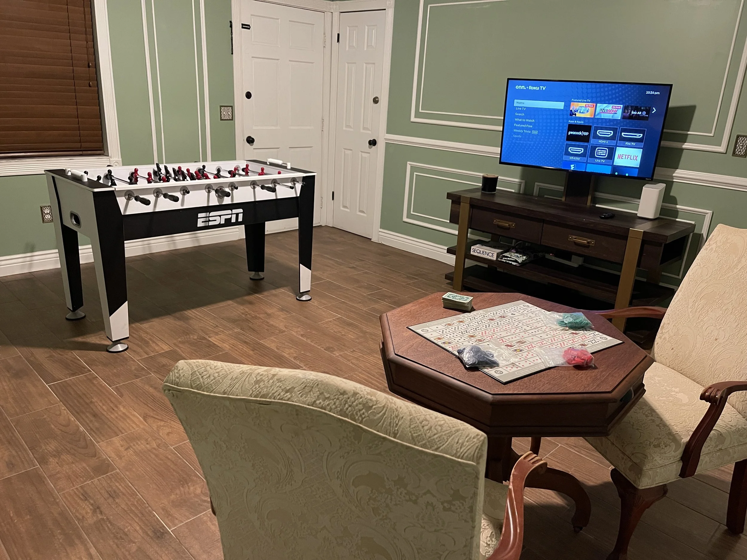 Airbnb game room with tv, board game table and foosball locate in Lake City, Florida.