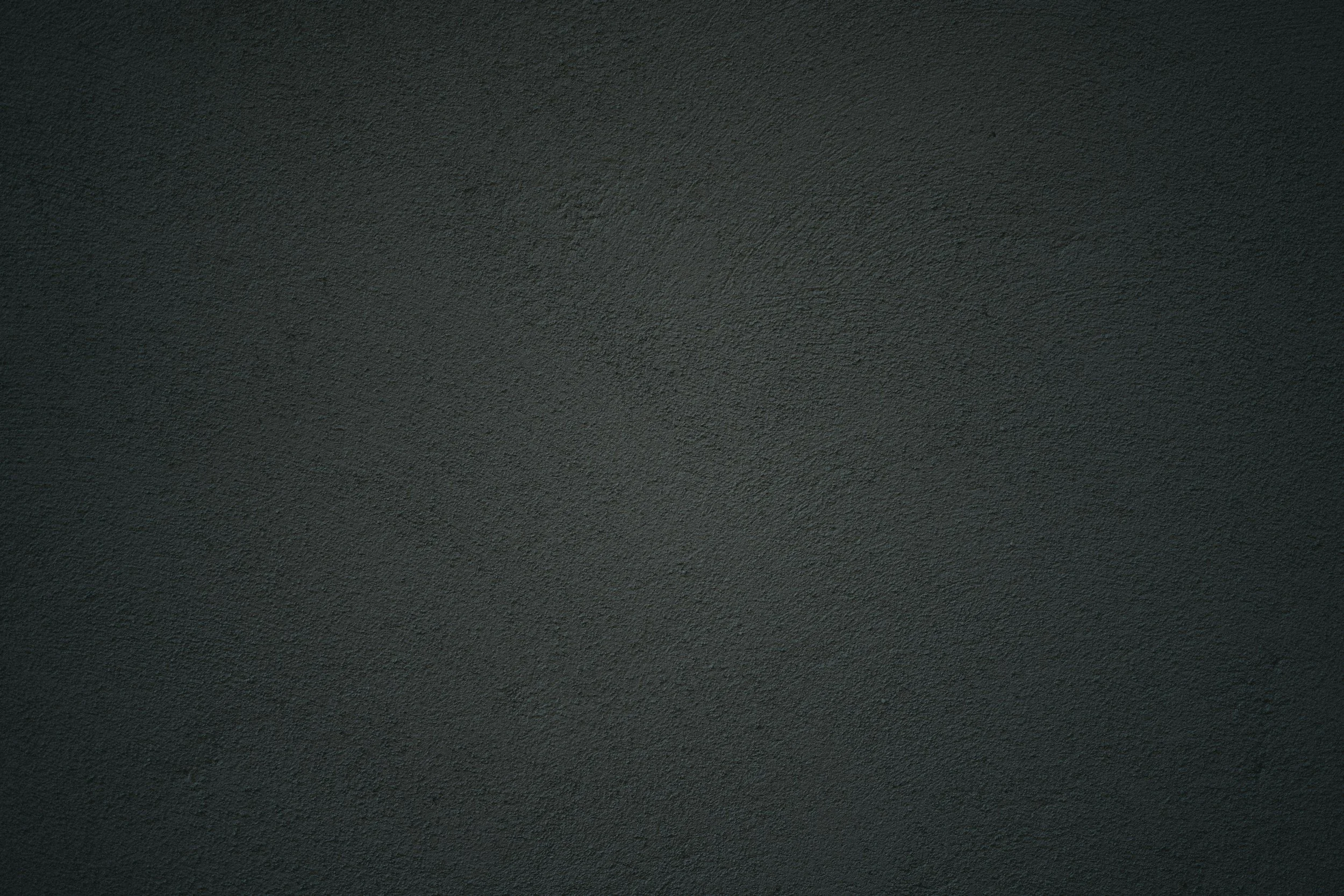 Solid dark gray textured wall or surface.