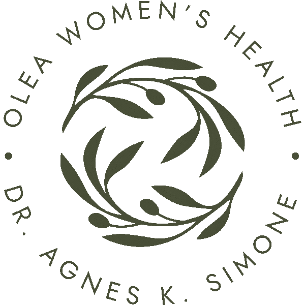 A circular logo with an olive branch design in the center, surrounded by the text 'Olive Women's Health Dr. Agnes K. Simone' around the circumference.