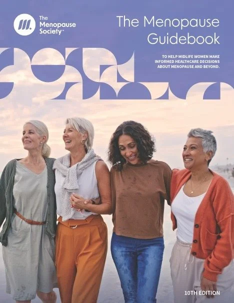 Cover of The Menopause Guidebook by The Menopause Society, showing four women smiling and walking outdoors with a cloudy sky background.