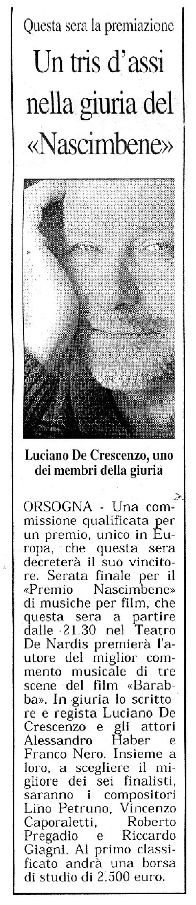 Articolo di giornale in italiano con una foto di un uomo anziano con barba e occhi chiusi, che sembra sorridere. Titolo: 'Un tris d'assi nella giuria del Nasibene'.