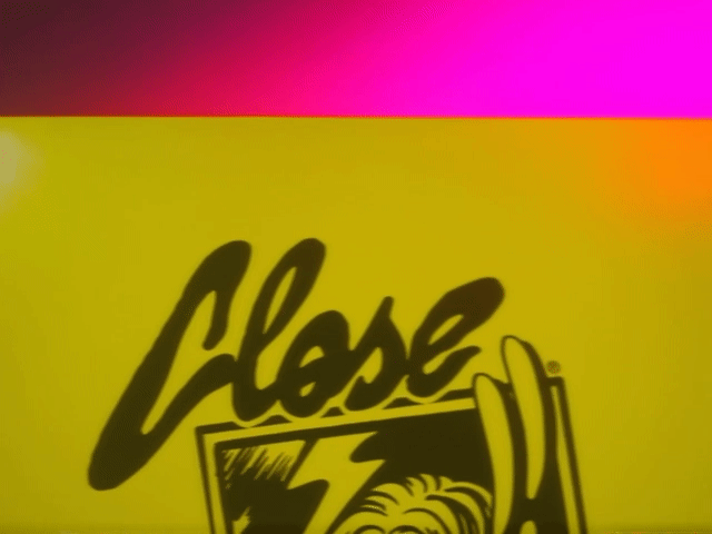 Close-up of a yellow sign with the word 'Close' written in black, with a graphic of an open door.