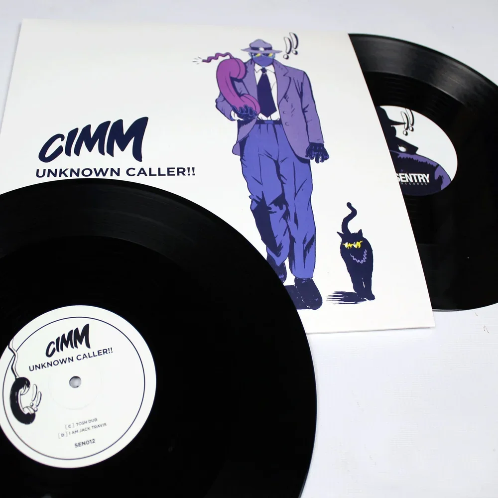 Two black vinyl records with white labels featuring text and illustrations. The cover art depicts an illustrated man in a suit with a hat and sunglasses, holding a purple object over his shoulder, and a black cat with yellow eyes and sharpened teeth.