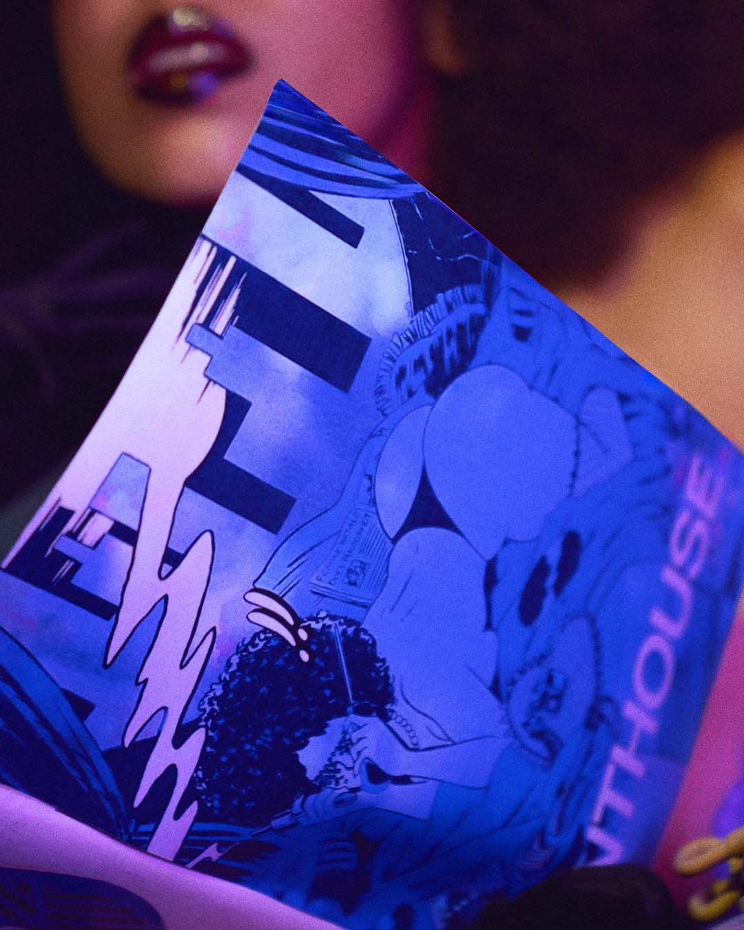 Close-up of a comic book being held, showing a female character with curly hair, and a speech bubble with the word 'WHO' in bold letters, with purple and pink lighting.