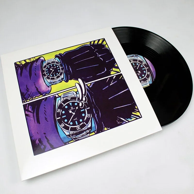 Vinyl record partially inside album cover with pop art style image of a person's arm wearing a watch.