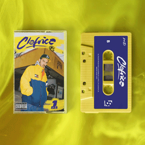 A cassette tape and a cassette tape case with an album cover featuring a person in a yellow and blue jacket, set against a yellow background