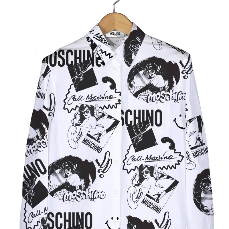 Black and white printed button-up shirt with cartoon graphics and text, hanging on a wooden hanger