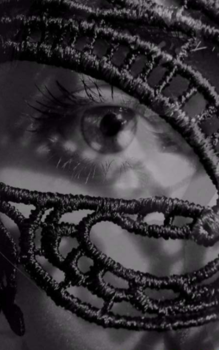Close-up of a human eye with dreadlocks in black and white.