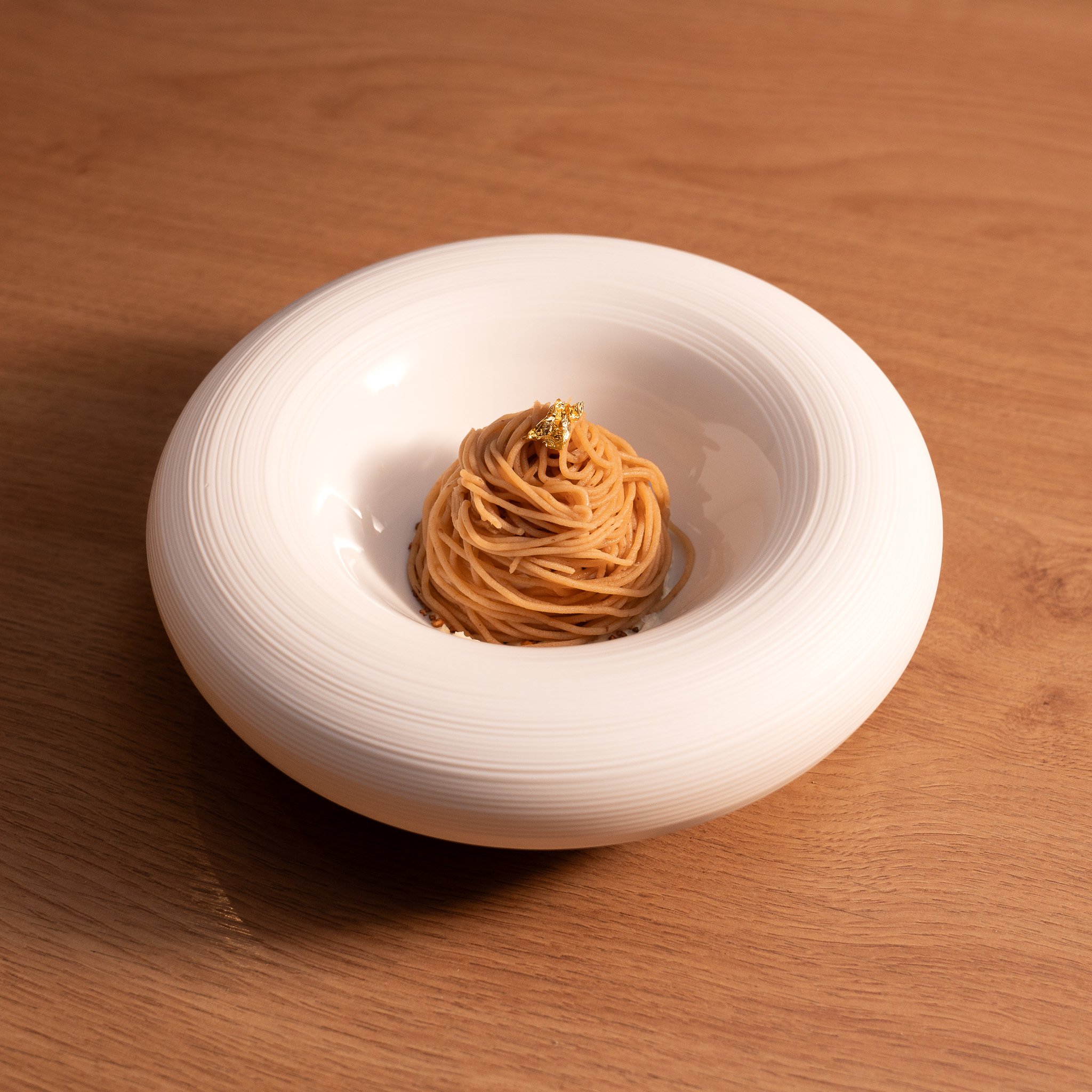 TAKU’s Mont Blanc dessert with whiskey mascarpone cream, buckwheat sponge, sobacha crunch, chestnut ice cream, and chestnut cream, reimagined with a Japanese twist.